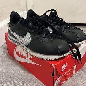 WOMENS Nike Cortez black leather with fuzzy grey swoosh